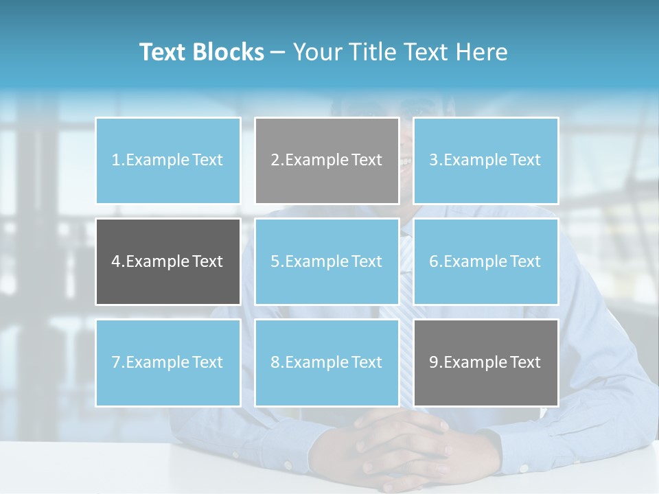 A Man In A Blue Shirt And Tie Sitting At A Table PowerPoint Template