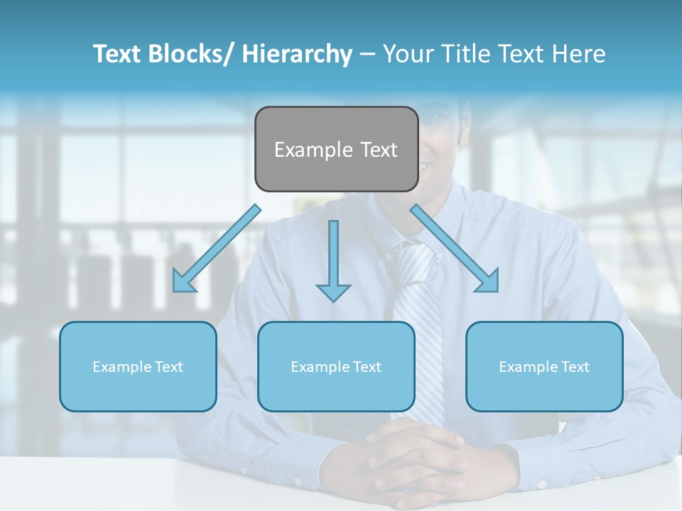 A Man In A Blue Shirt And Tie Sitting At A Table PowerPoint Template