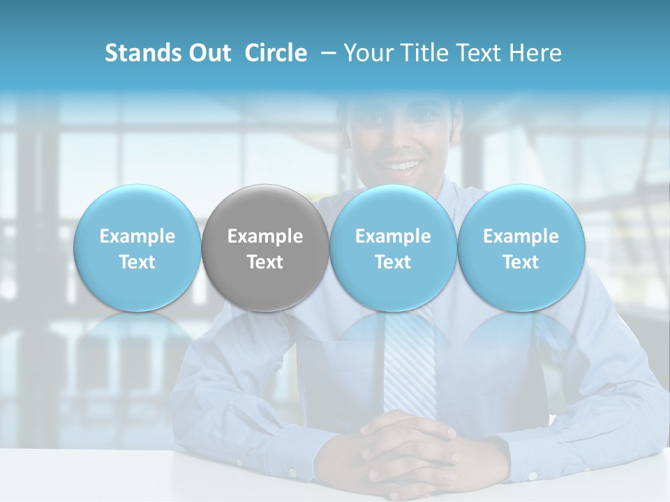 A Man In A Blue Shirt And Tie Sitting At A Table PowerPoint Template