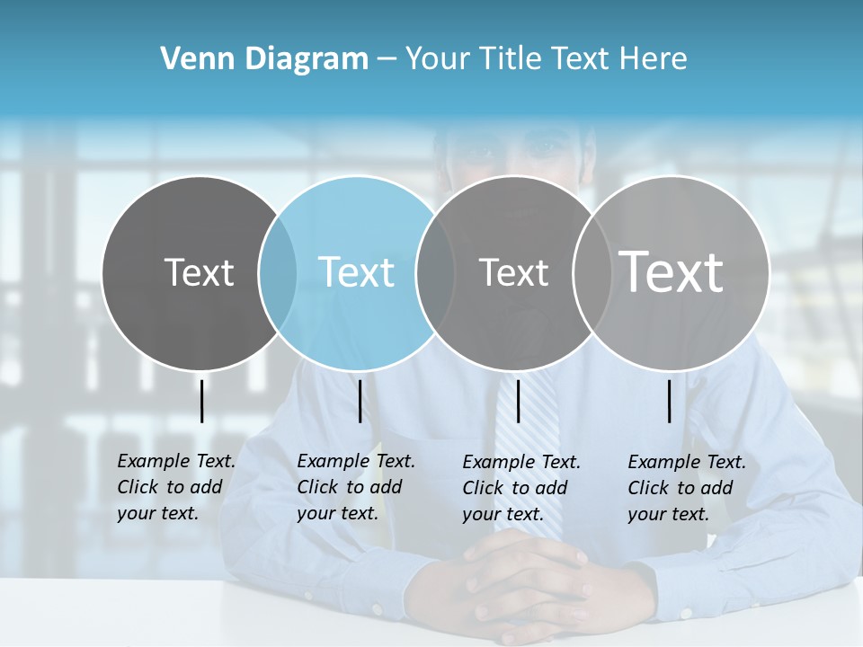 A Man In A Blue Shirt And Tie Sitting At A Table PowerPoint Template