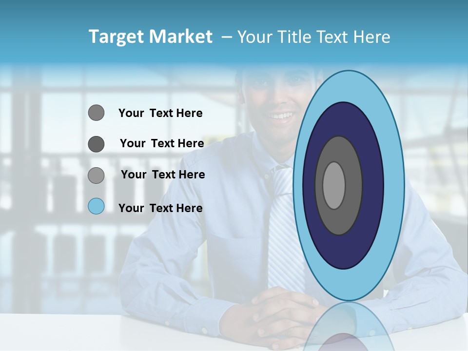 A Man In A Blue Shirt And Tie Sitting At A Table PowerPoint Template