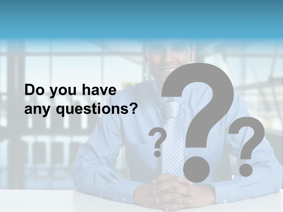 A Man In A Blue Shirt And Tie Sitting At A Table PowerPoint Template