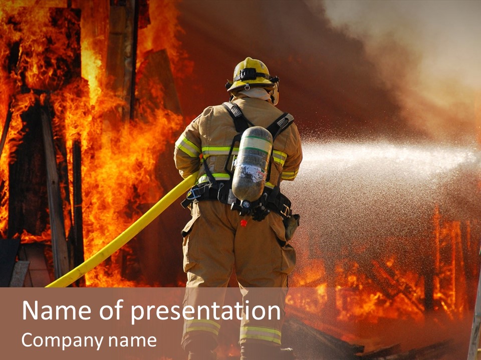 A Firefighter Spraying Water On A Fire PowerPoint Template