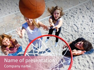 A Group Of Kids Playing Basketball In The Sand PowerPoint Template