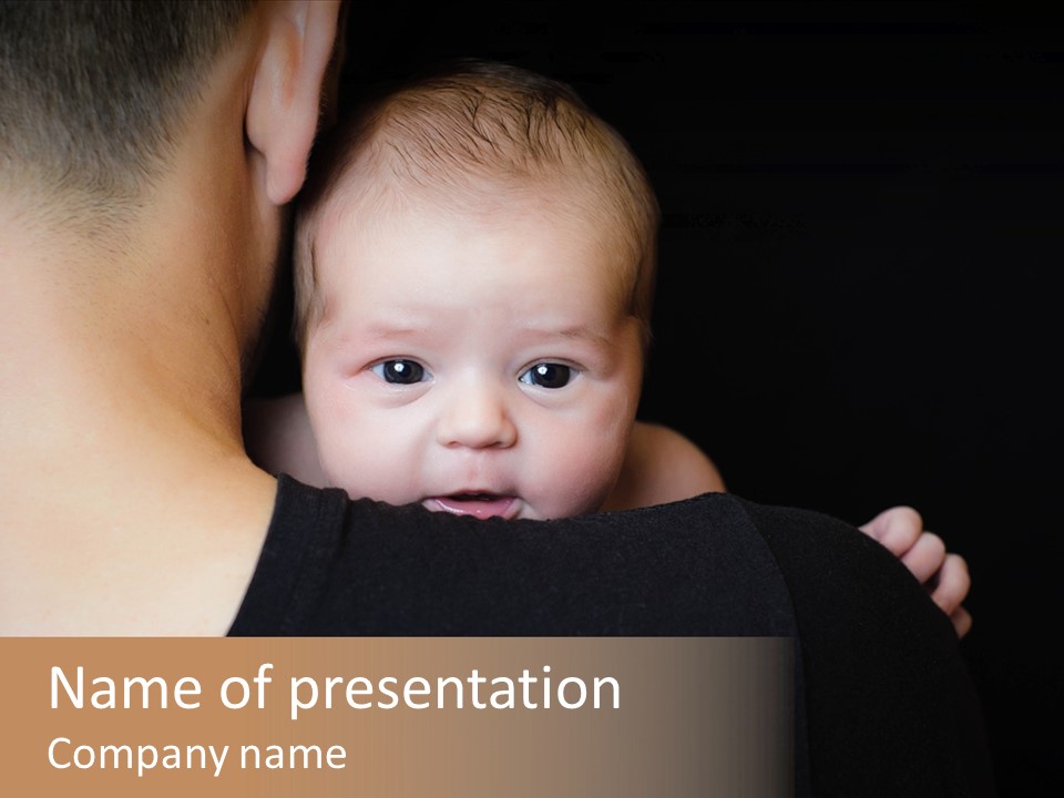 A Man Holding A Baby In His Arms PowerPoint Template