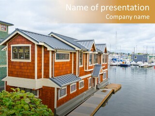 A Row Of Houses Sitting Next To A Body Of Water PowerPoint Template