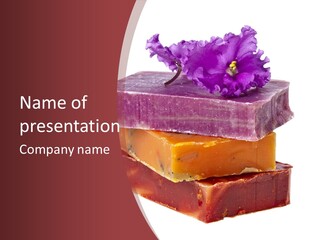 Three Soap Bars With A Purple Flower On Top Of Them PowerPoint Template