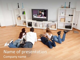 A Group Of People Sitting On The Floor Watching Tv PowerPoint Template