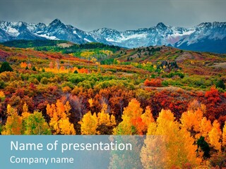 A Scenic View Of A Mountain Range With Colorful Trees PowerPoint Template