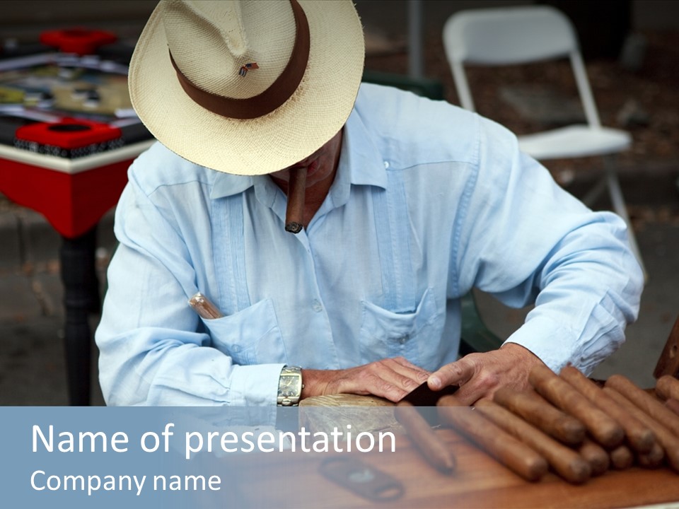 A Man In A Hat Is Working On A Piece Of Wood PowerPoint Template