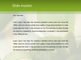A Glass Filled With Green Liquid Next To Sliced Cucumbers PowerPoint Template