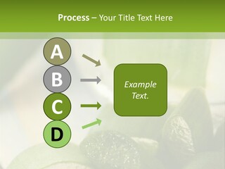 A Glass Filled With Green Liquid Next To Sliced Cucumbers PowerPoint Template