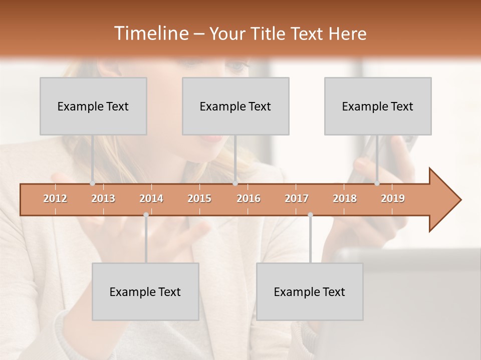 A Woman Sitting At A Table Using A Laptop Computer PowerPoint Template