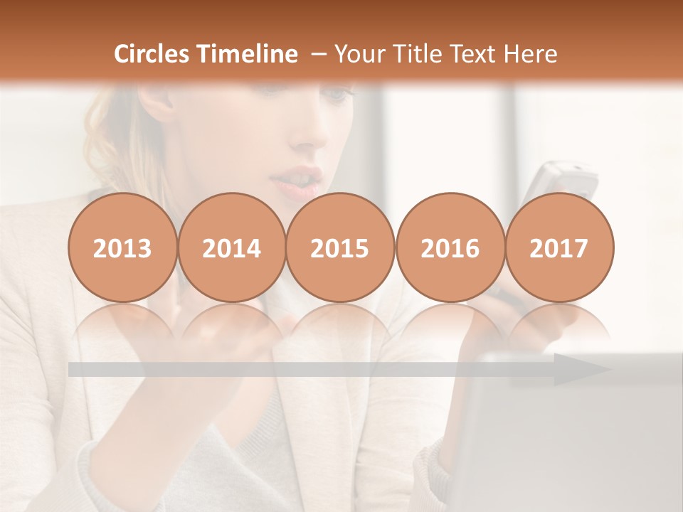 A Woman Sitting At A Table Using A Laptop Computer PowerPoint Template