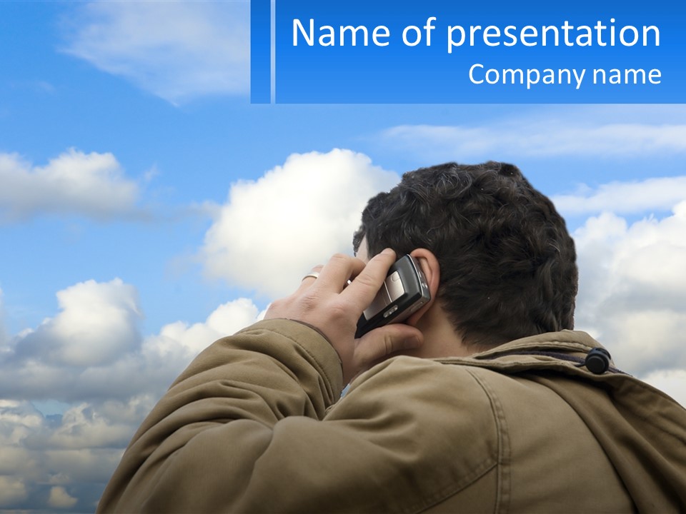 A Man Talking On A Cell Phone With Clouds In The Background PowerPoint Template