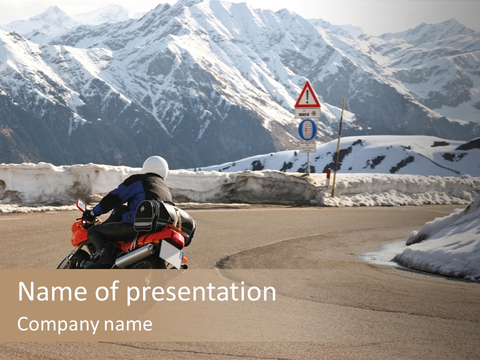 A Person Riding A Motorcycle On A Road With Mountains In The Background PowerPoint Template