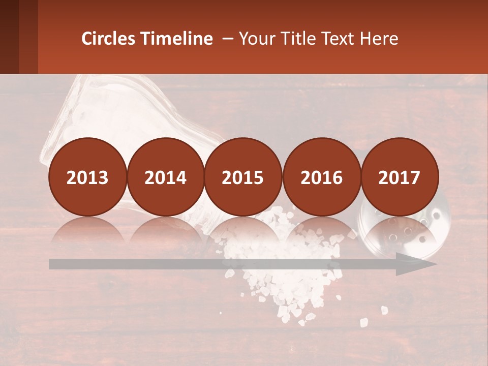 A Salt Shaker And A Scoop Of Salt On A Wooden Table PowerPoint Template