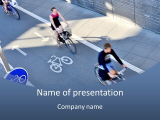A Group Of People Riding Bikes Down A Street PowerPoint Template