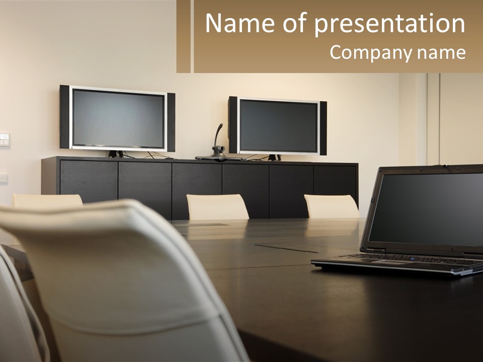 A Conference Table With A Laptop On It PowerPoint Template