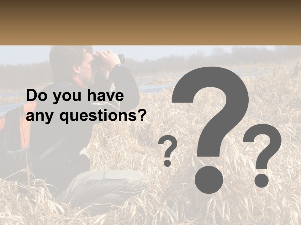 A Man Sitting In A Field Looking Through Binoculars PowerPoint Template