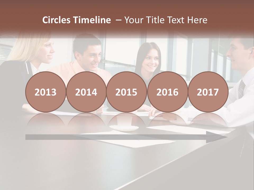 A Group Of Business People Sitting Around A Conference Table PowerPoint Template