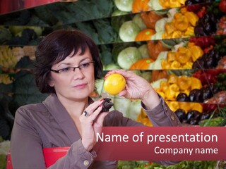 A Woman Holding An Orange In Front Of A Display Of Fruit PowerPoint Template