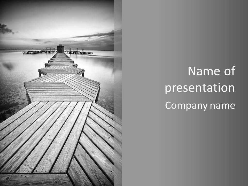 A Wooden Dock With Water And Clouds In The Background PowerPoint Template