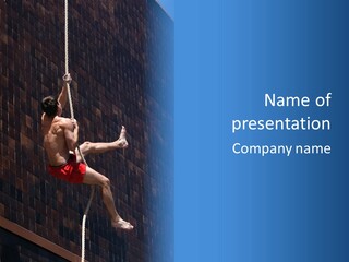 A Man Hanging From A Rope On A Building PowerPoint Template