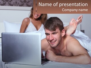A Man Laying On A Bed Using A Laptop Computer PowerPoint Template