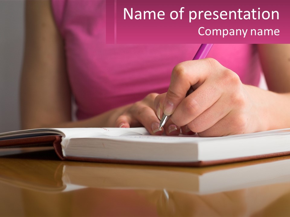 A Person Writing On A Book With A Pen PowerPoint Template