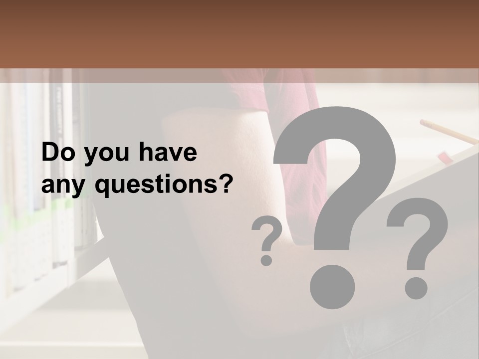 A Man Sitting In A Library Reading A Book PowerPoint Template