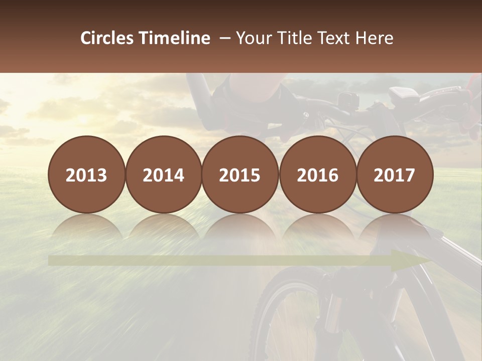 A Person Riding A Bike Down A Dirt Road PowerPoint Template