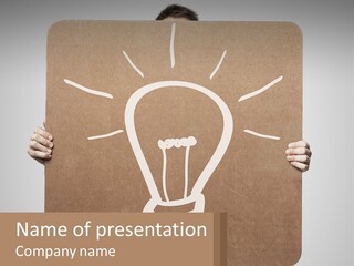 A Person Holding A Sign With A Light Bulb On It PowerPoint Template