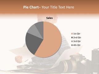 A Baby Reading A Book Next To A Camera PowerPoint Template