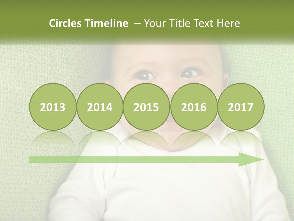 A Baby Laying On Top Of A Green Blanket PowerPoint Template