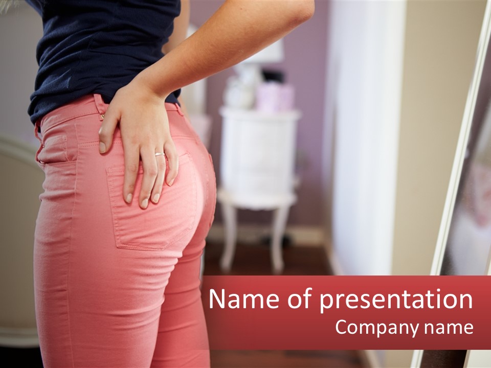 A Woman In Pink Pants Standing In Front Of A Mirror PowerPoint Template