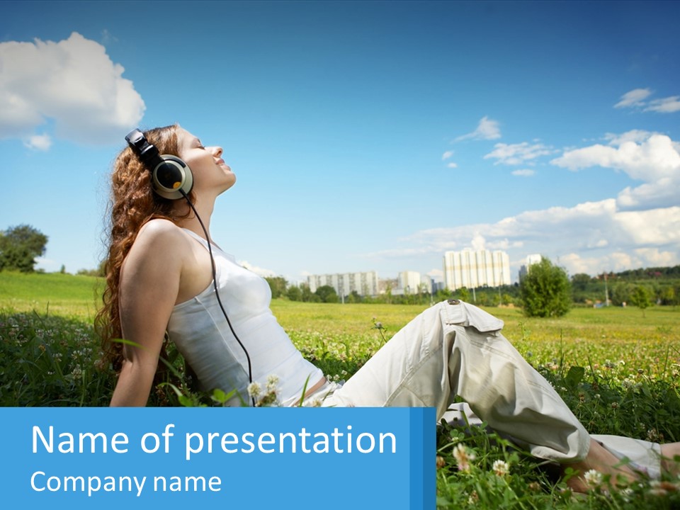 A Woman Sitting In The Grass Listening To Music PowerPoint Template