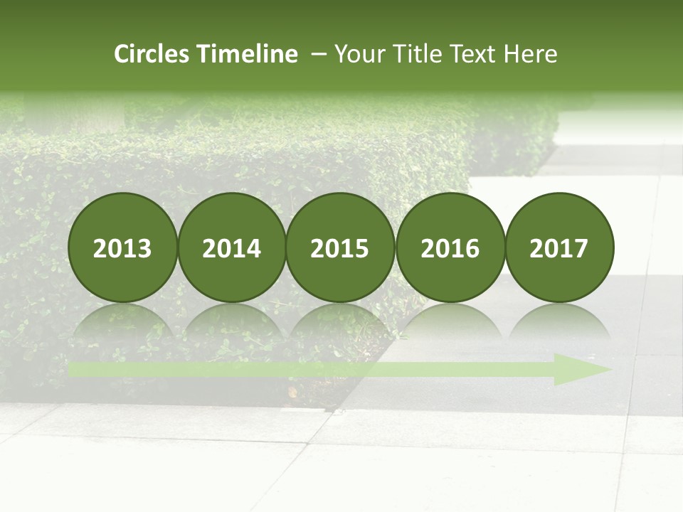 A Row Of Hedges On A Sidewalk In Front Of A Building PowerPoint Template