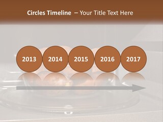 A Glass Bowl Filled With Apples On Top Of A Stove PowerPoint Template