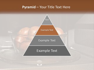 A Glass Bowl Filled With Apples On Top Of A Stove PowerPoint Template