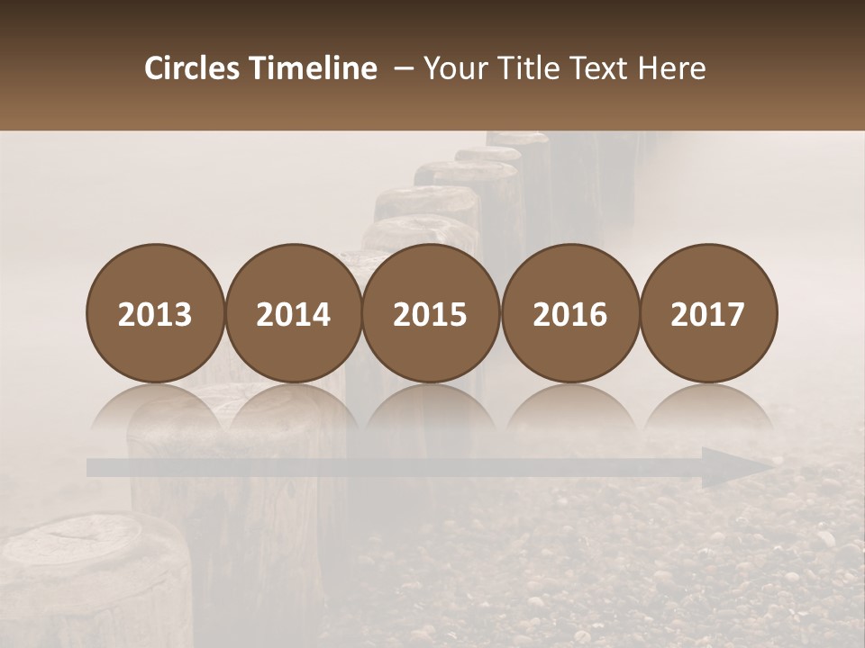 A Row Of Wooden Logs Sitting On Top Of A Beach PowerPoint Template