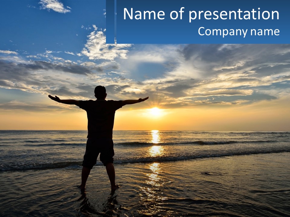 A Man Standing On The Beach With His Arms Outstretched PowerPoint Template