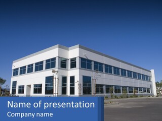 A Large White Building With A Blue Sign In Front Of It PowerPoint Template