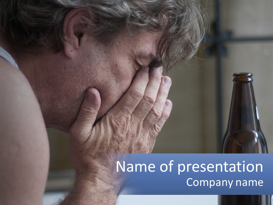 A Man Holding His Face Next To A Bottle Of Beer PowerPoint Template