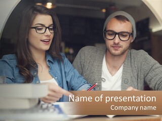 A Man And A Woman Sitting At A Table Looking At A Tablet PowerPoint Template
