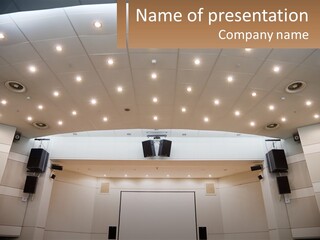A Large Auditorium With Speakers And Lights On The Ceiling PowerPoint Template