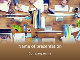 A Group Of People Sitting At A Table Working On Laptops PowerPoint Template