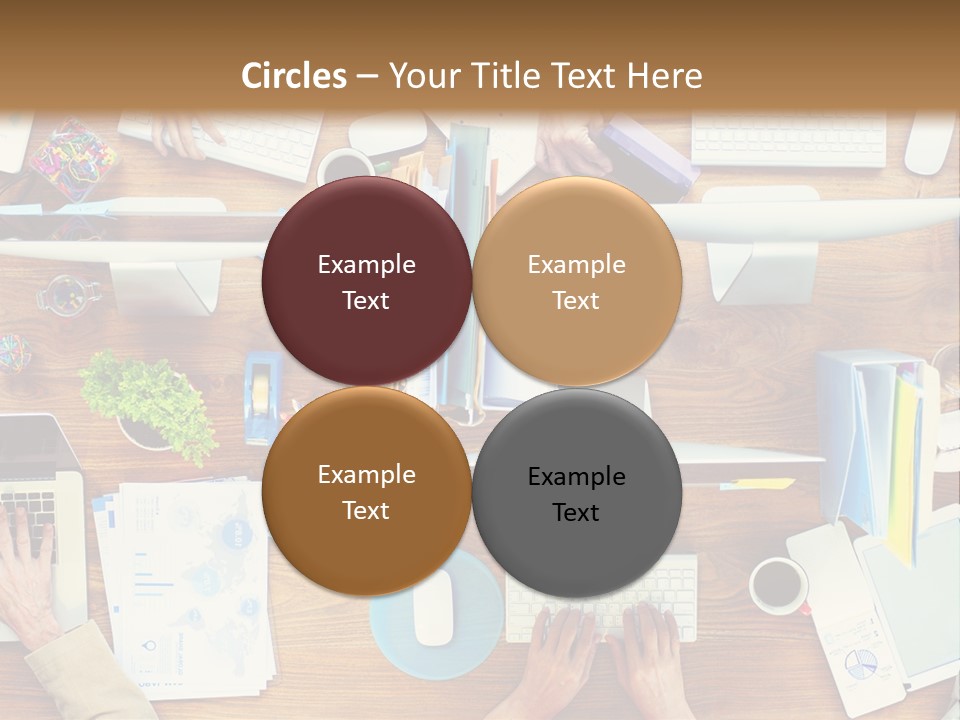 A Group Of People Sitting At A Table Working On Laptops PowerPoint Template
