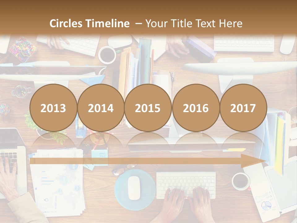 A Group Of People Sitting At A Table Working On Laptops PowerPoint Template