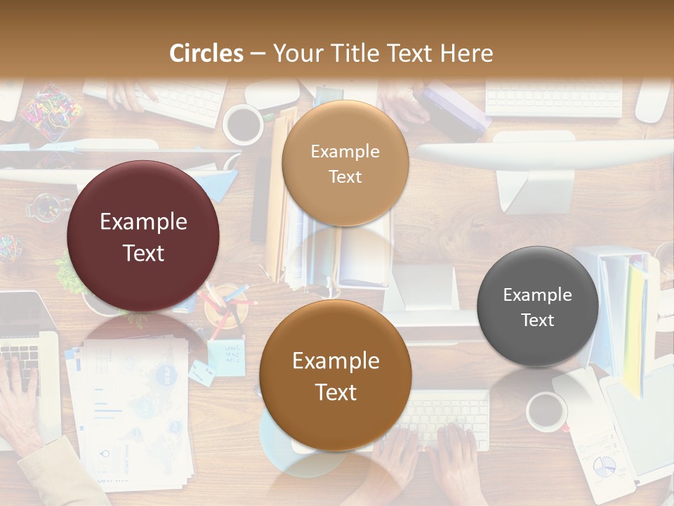 A Group Of People Sitting At A Table Working On Laptops PowerPoint Template